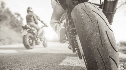 image of a back of a motorcycle on a paved road