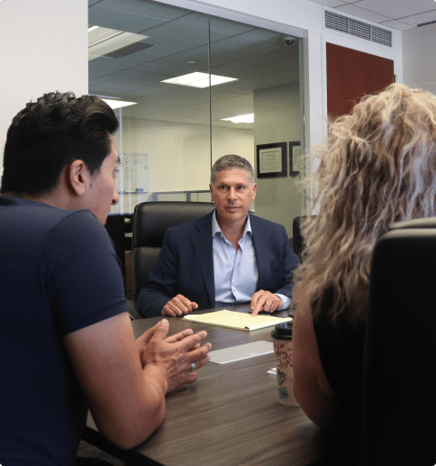 mitchell talking with clients at a table