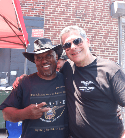 mitchell with is arm around a fellow motorcycle advocate at an event