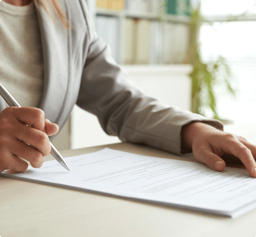 woman filling out a law form with a pen