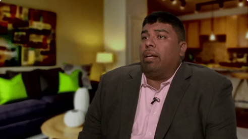 black man in a suit doing an interview for the law firm