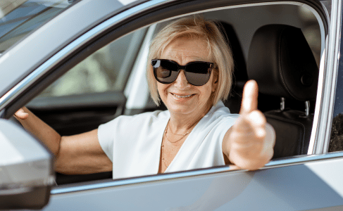 woman driver giving thumbs up