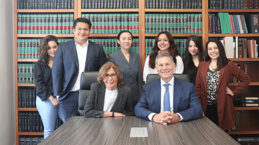 mitchell proner and his team in an office with a book case in the background