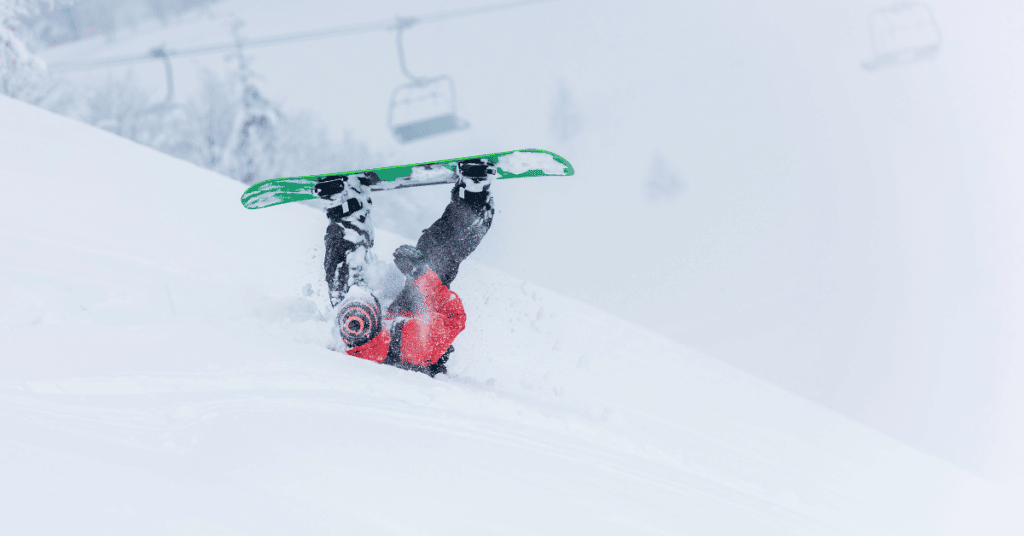 snowboarder who fell on a snowy ski slope