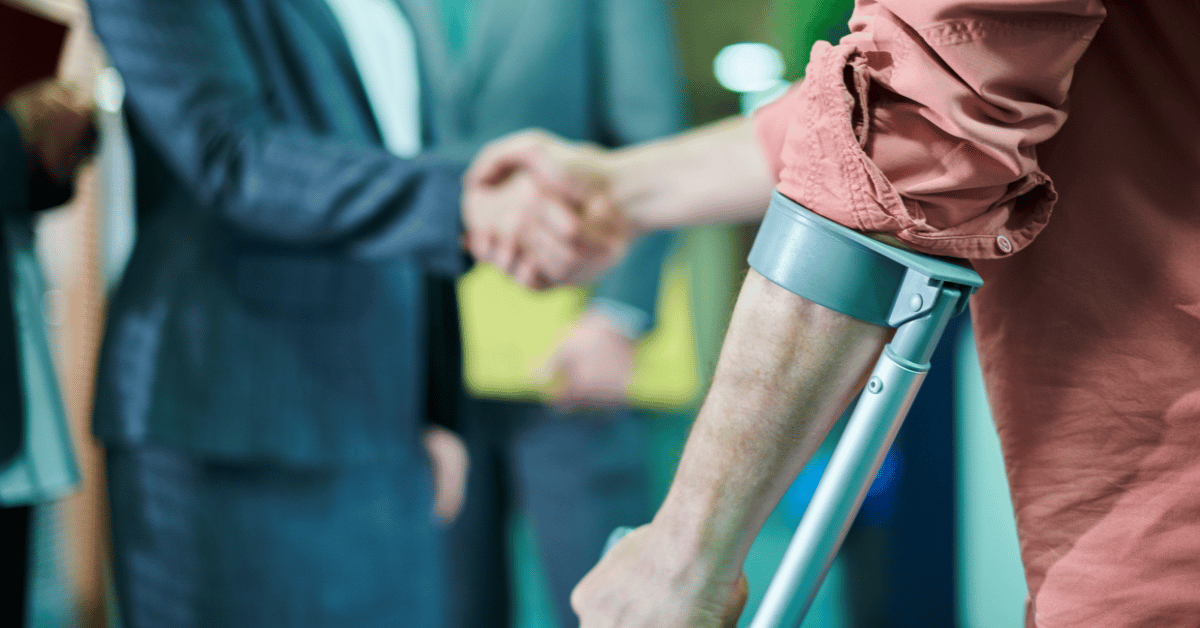 lawyer shaking hand with man using a crutch